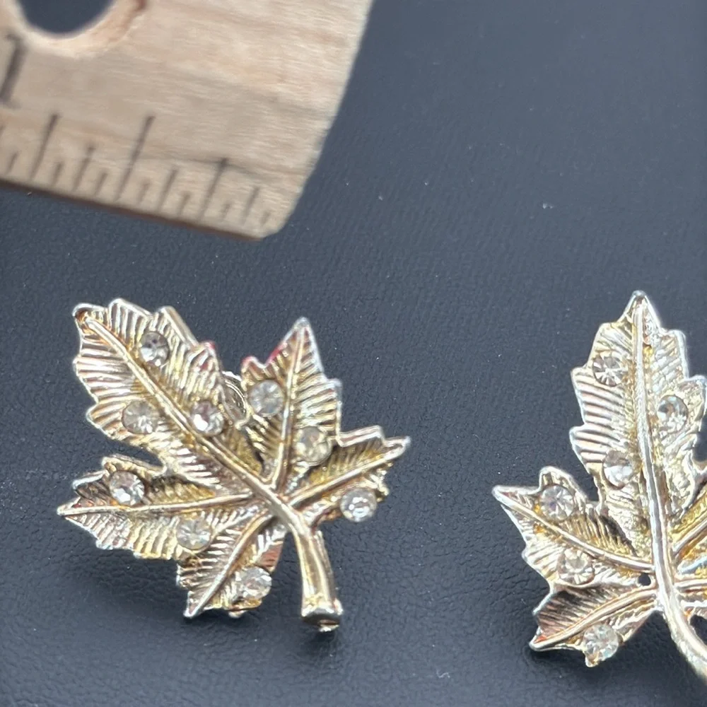 Gold tone textured leaf rhinestone accent screw back statement earrings